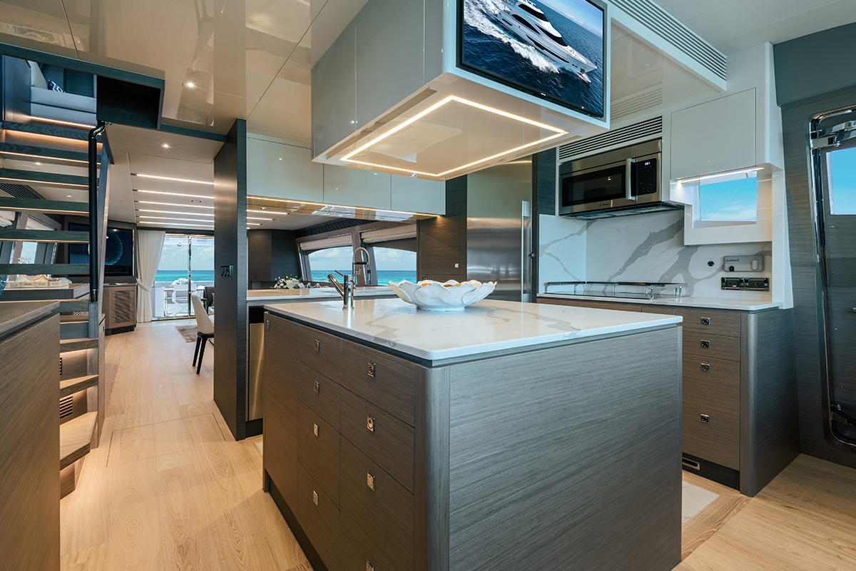 Full galley with island, refrigerator and TV.